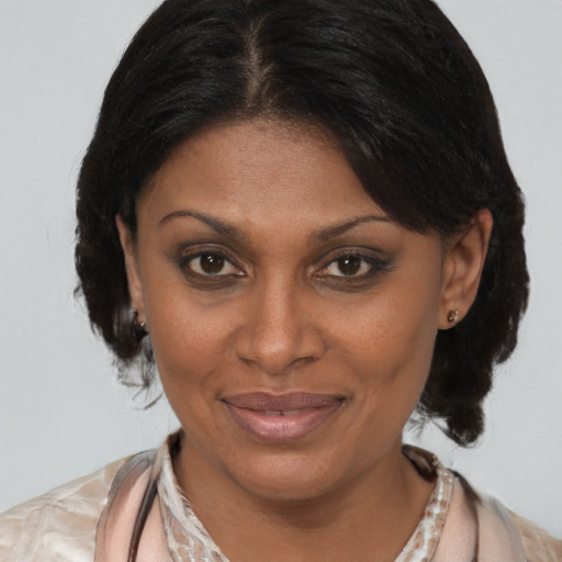 Joyful latino adult female with medium  brown hair and brown eyes