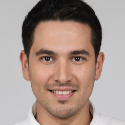 Joyful white young-adult male with short  brown hair and brown eyes