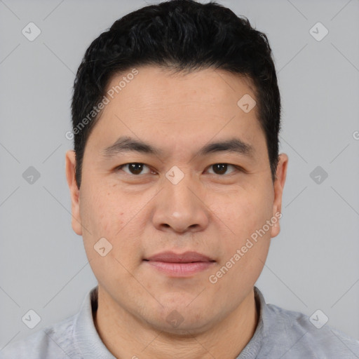 Joyful asian young-adult male with short  black hair and brown eyes