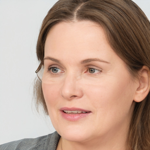 Joyful white adult female with medium  brown hair and grey eyes