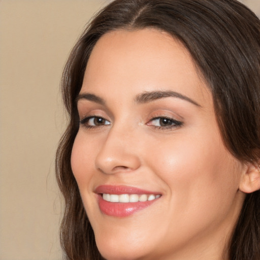 Joyful white young-adult female with long  brown hair and brown eyes