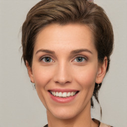 Joyful white young-adult female with medium  brown hair and green eyes