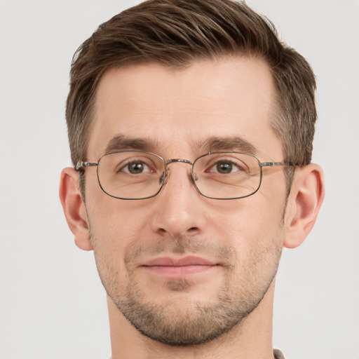 Joyful white adult male with short  brown hair and grey eyes