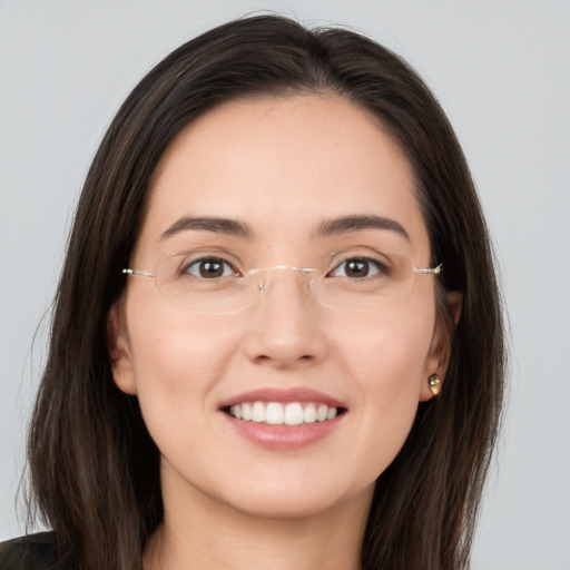 Joyful white young-adult female with long  brown hair and brown eyes