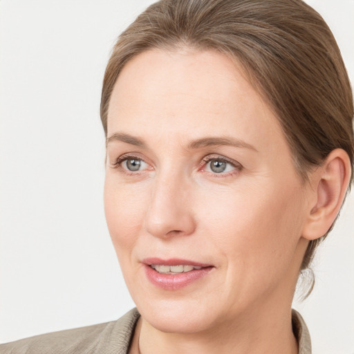 Joyful white adult female with medium  brown hair and grey eyes