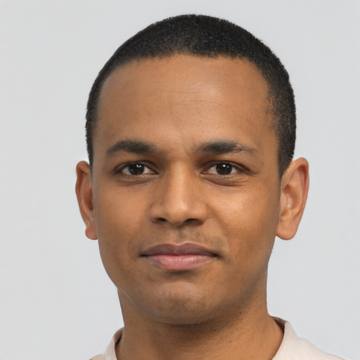 Joyful black young-adult male with short  black hair and brown eyes