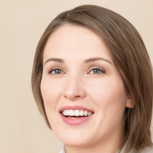 Joyful white young-adult female with medium  brown hair and green eyes