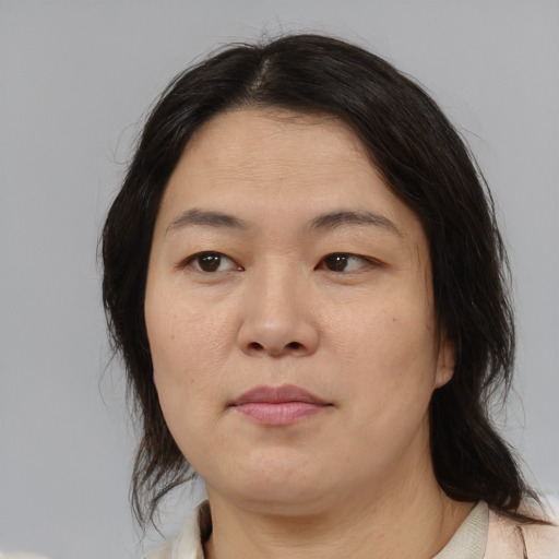 Neutral asian adult female with medium  brown hair and brown eyes