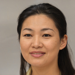 Joyful asian adult female with medium  brown hair and brown eyes