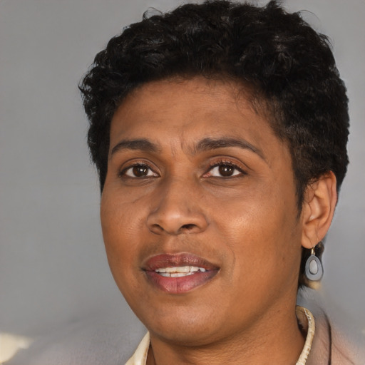 Joyful black adult female with short  brown hair and brown eyes