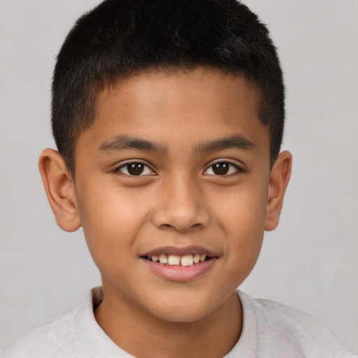 Joyful latino child male with short  brown hair and brown eyes