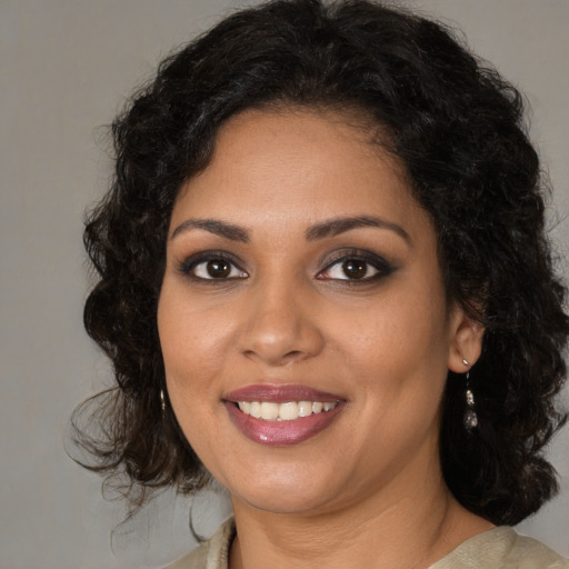 Joyful black young-adult female with medium  brown hair and brown eyes