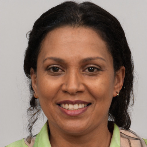 Joyful latino adult female with short  brown hair and brown eyes
