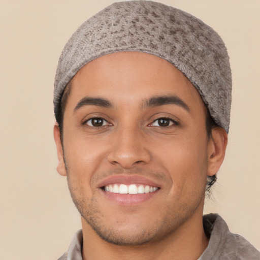 Joyful white young-adult male with short  black hair and brown eyes