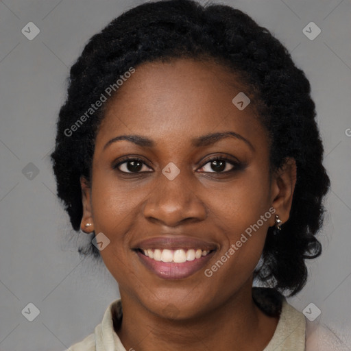 Joyful black young-adult female with long  black hair and brown eyes