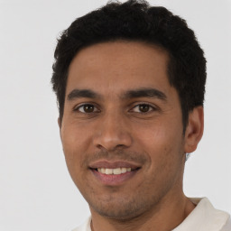 Joyful latino young-adult male with short  black hair and brown eyes
