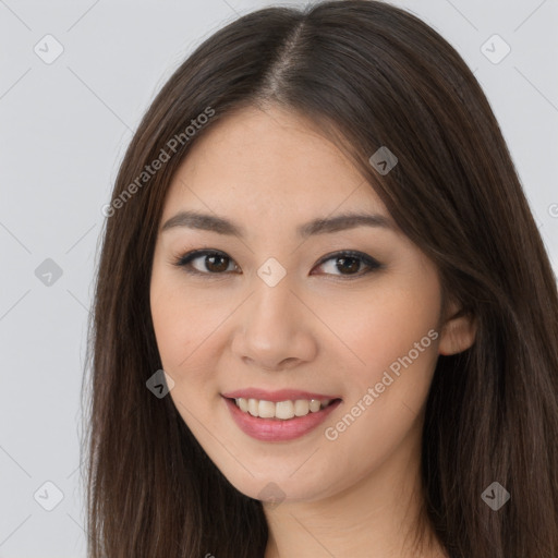 Joyful asian young-adult female with long  brown hair and brown eyes