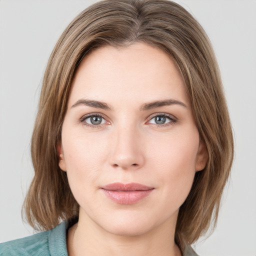 Joyful white young-adult female with medium  brown hair and green eyes