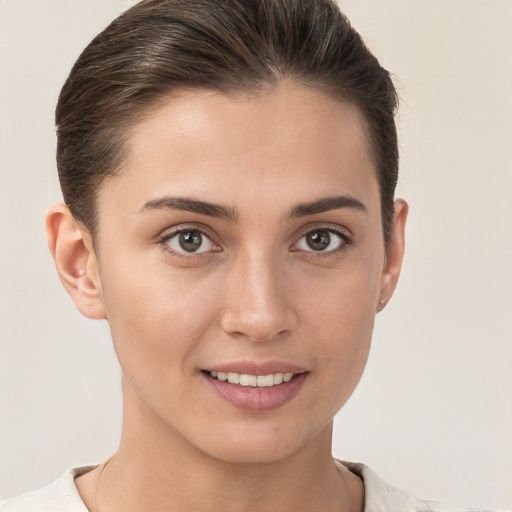 Joyful white young-adult female with short  brown hair and brown eyes