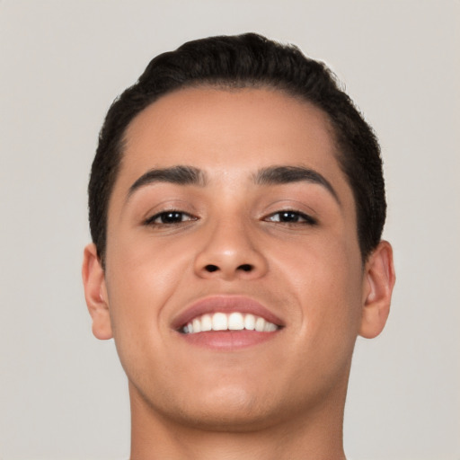 Joyful latino young-adult male with short  brown hair and brown eyes