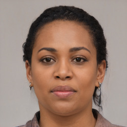 Joyful black young-adult female with medium  black hair and brown eyes