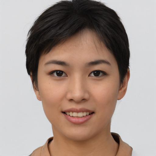 Joyful asian young-adult female with short  brown hair and brown eyes