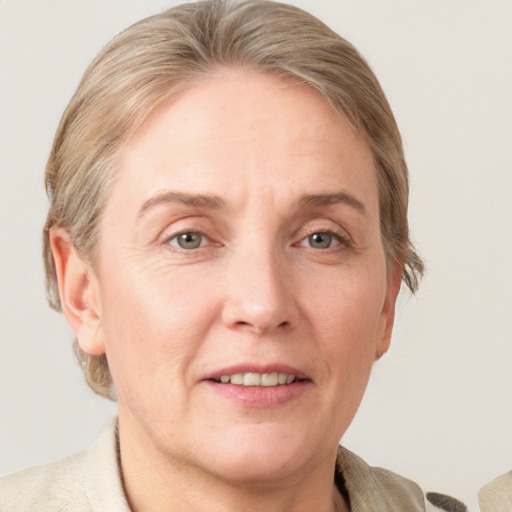 Joyful white adult female with medium  brown hair and blue eyes