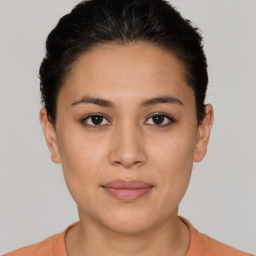 Joyful latino young-adult female with short  brown hair and brown eyes