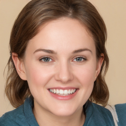 Joyful white young-adult female with medium  brown hair and grey eyes