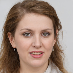 Joyful white young-adult female with long  brown hair and green eyes