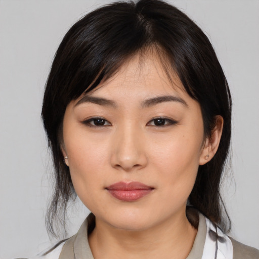 Joyful asian young-adult female with medium  brown hair and brown eyes