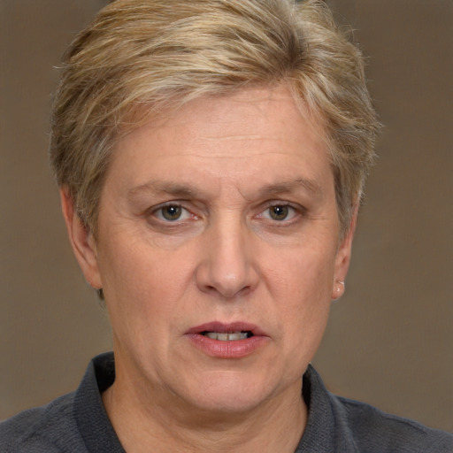 Joyful white middle-aged female with short  brown hair and blue eyes