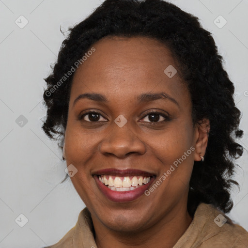 Joyful black young-adult female with long  brown hair and brown eyes