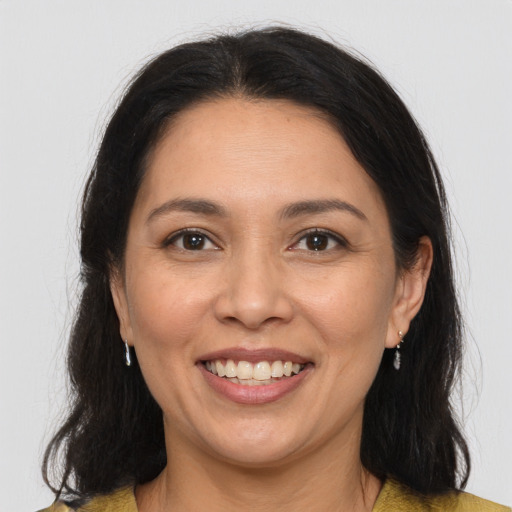 Joyful white adult female with long  brown hair and brown eyes