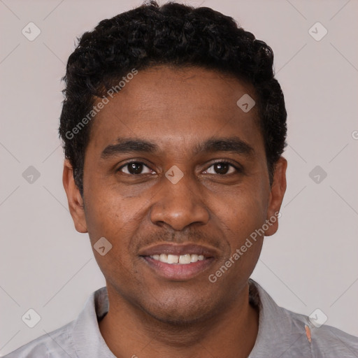 Joyful black young-adult male with short  black hair and brown eyes