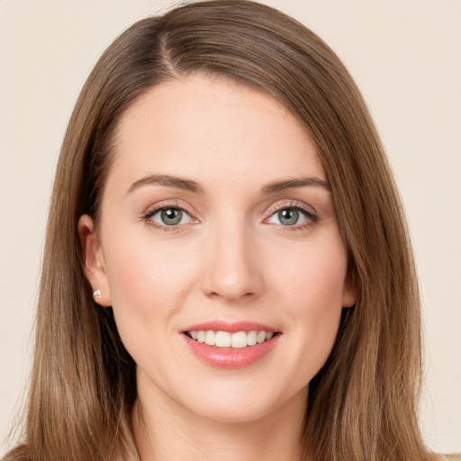 Joyful white young-adult female with long  brown hair and grey eyes