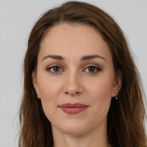 Joyful white young-adult female with long  brown hair and brown eyes