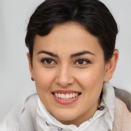 Joyful latino young-adult female with short  brown hair and brown eyes