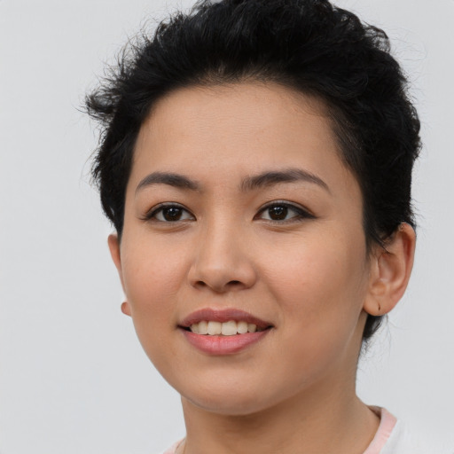 Joyful asian young-adult female with short  brown hair and brown eyes