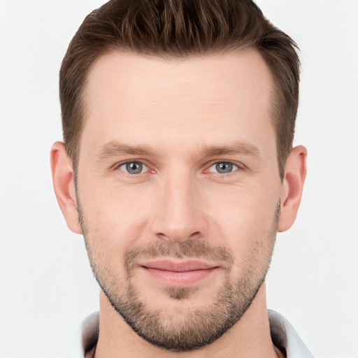 Joyful white young-adult male with short  brown hair and grey eyes