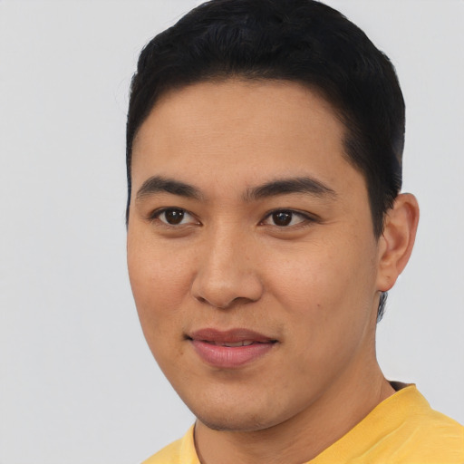 Joyful asian young-adult male with short  black hair and brown eyes
