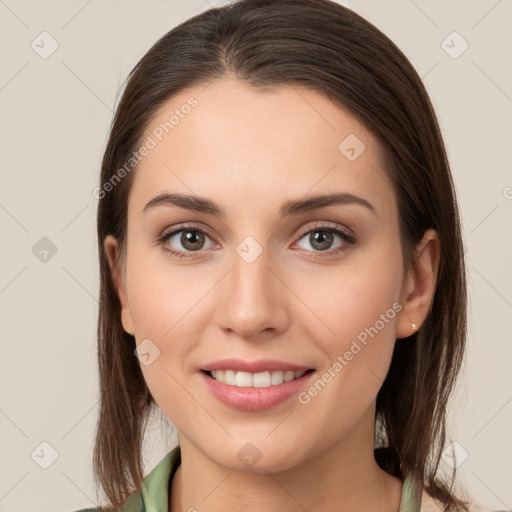 Joyful white young-adult female with long  brown hair and brown eyes