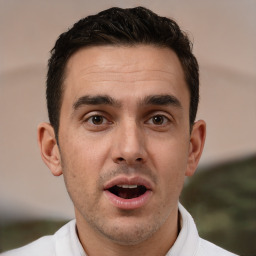 Joyful white adult male with short  brown hair and brown eyes