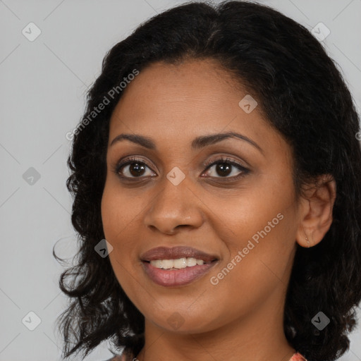 Joyful black young-adult female with long  brown hair and brown eyes