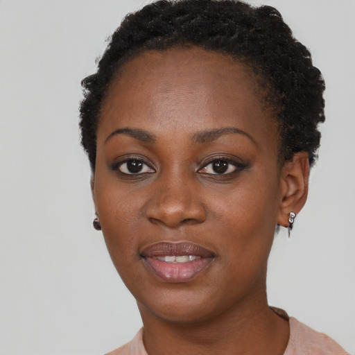 Joyful black young-adult female with short  black hair and brown eyes