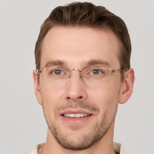 Joyful white young-adult male with short  brown hair and grey eyes