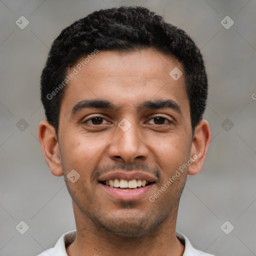 Joyful latino young-adult male with short  black hair and brown eyes