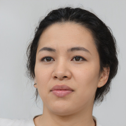 Joyful asian young-adult female with medium  black hair and brown eyes