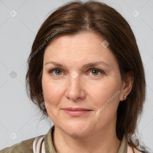 Joyful white adult female with medium  brown hair and grey eyes