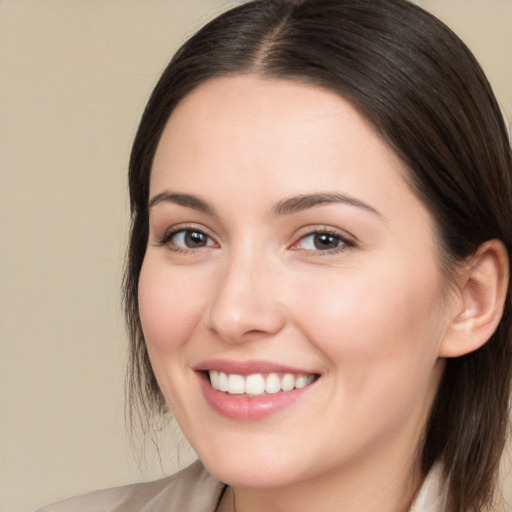 Joyful white young-adult female with medium  brown hair and brown eyes